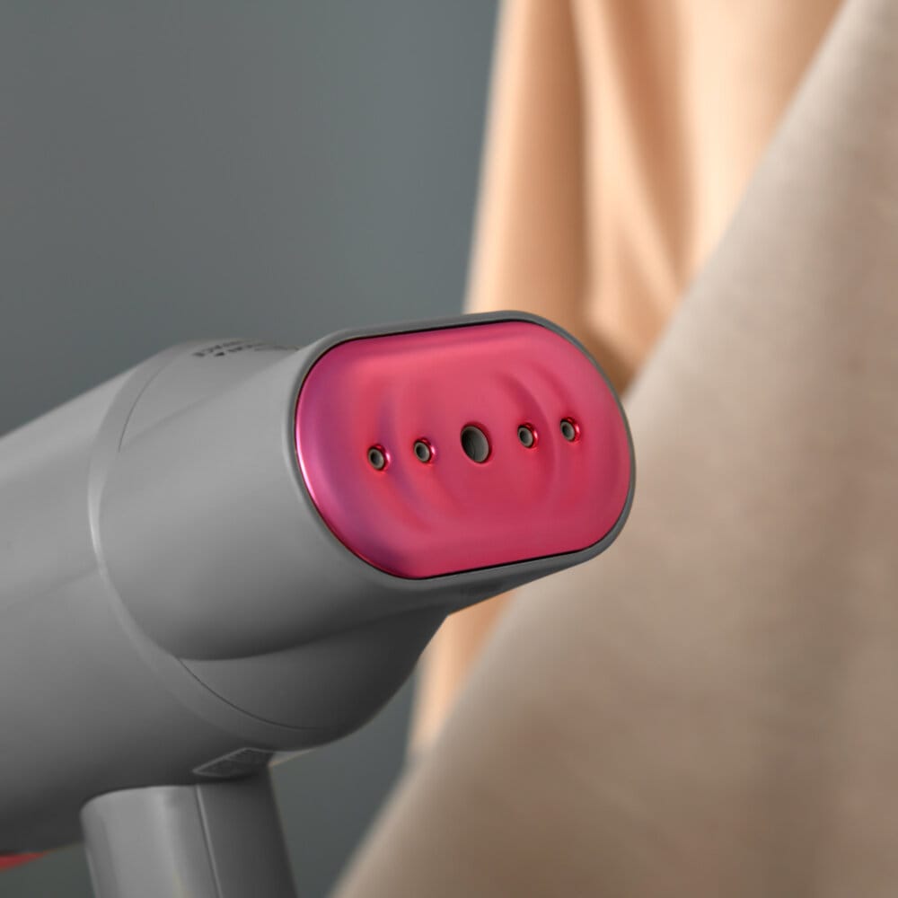 Ein faltbarer Dampfglätter und Handdampfer in Grau und Rosa mit 1520W Leistung.