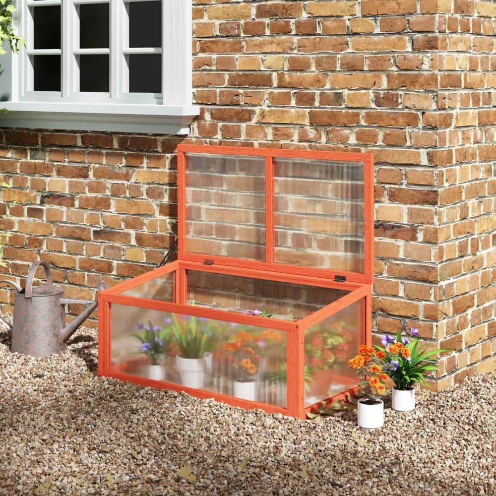 Wetterfestes oranges Frühbeet aus Holz und Polycarbonat, schützt Pflanzen vor Witterungseinflüssen und fördert das Wachstum.