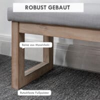 Eine graue Fussbank und Polsterhocker mit Holzbeinen.