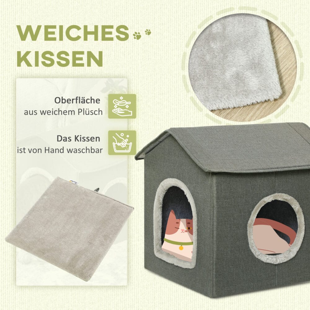 Graue Katzenhöhle in Hausform mit bequemem Kissen und zwei Türen, bietet einen gemütlichen Rückzugsort für Katzen.