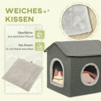 Graue Katzenhöhle in Hausform mit bequemem Kissen und zwei Türen, bietet einen gemütlichen Rückzugsort für Katzen.