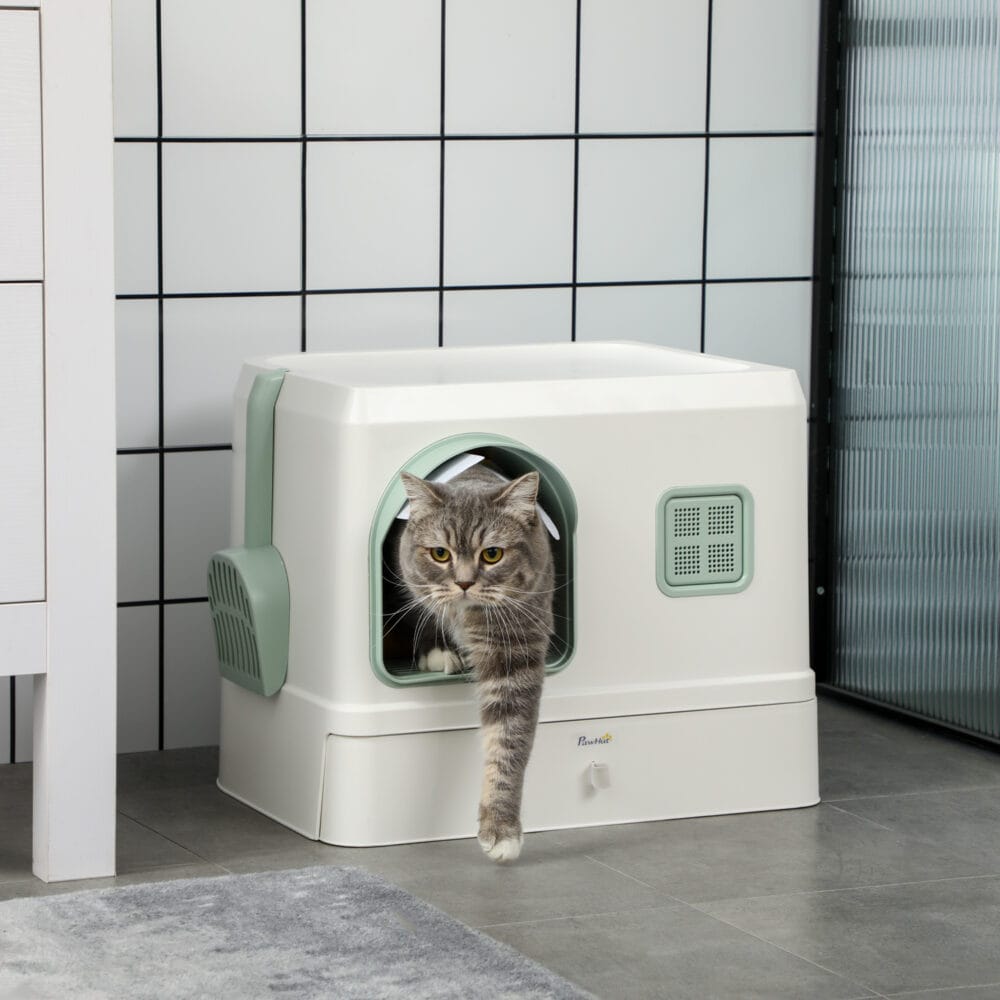 Weiss-grünes Katzenklo mit Schaufel, Schublade und Deodorant, für eine umfassende Hygiene und einfache Wartung.