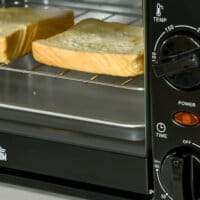 Ein kleiner schwarzer Backofen mit 10 Litern Fassungsvermögen, 750W Leistung und einem 60-Minuten-Timer.