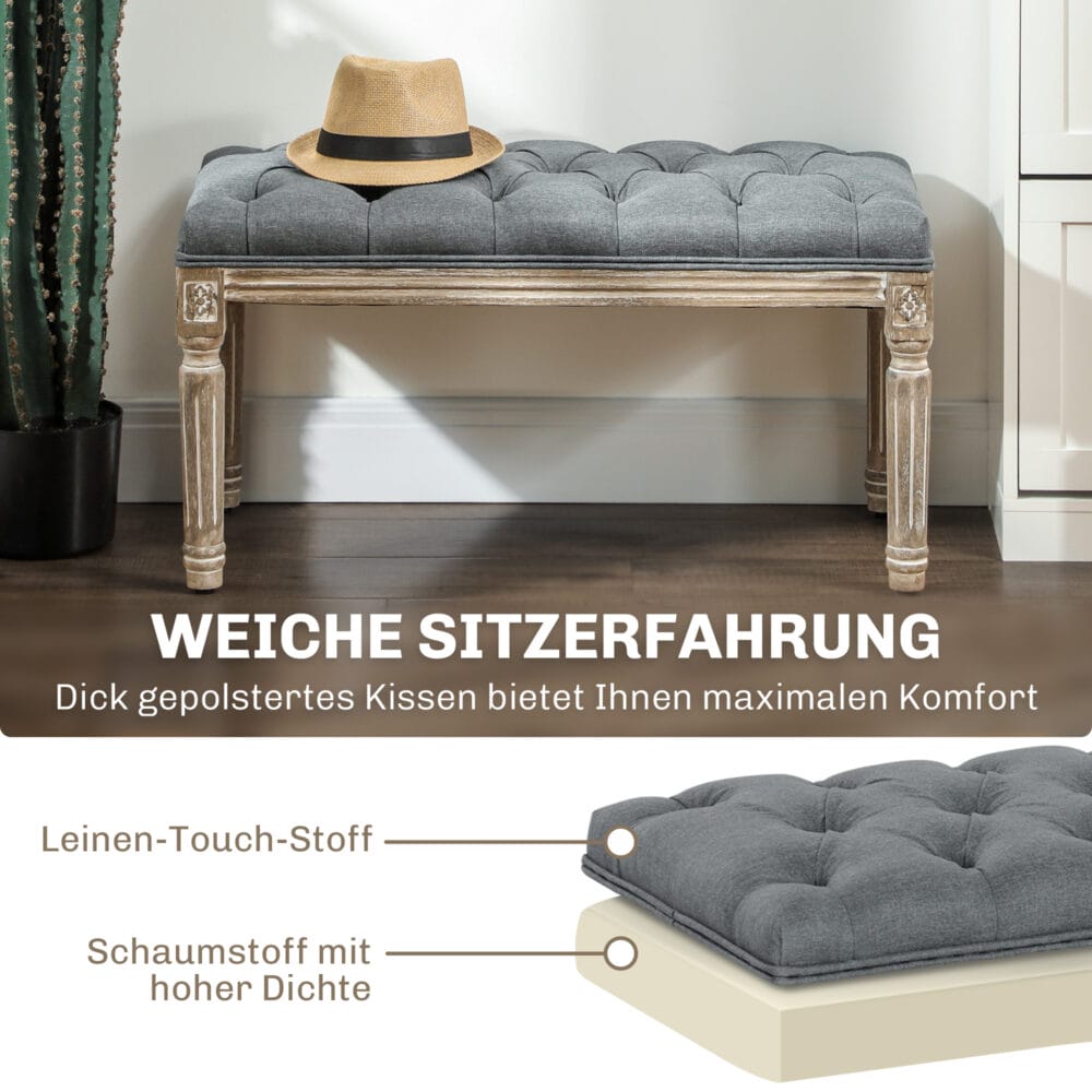 Graue Polsterbank im Vintage-Stil mit eleganter Knopfverzierung. Ein zeitloses Möbelstück für klassische Einrichtungen.