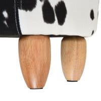 Ein niedlicher Tierhocker im Schweinchen-Design mit integriertem Stauraum in Schwarz-Weiss.